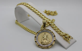 a picture of a cuban link chain and religious pendant 